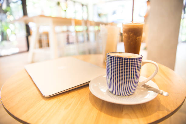 istock laptop with fresh cup of coffee, top view. 962119810