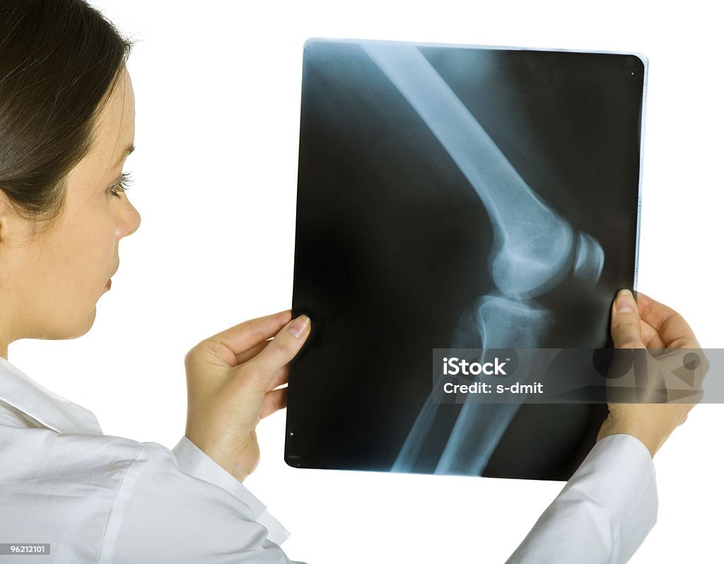 Young attractive female doctor looking x-ray photos  Adult Stock Photo