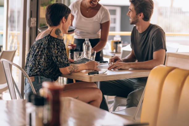 istock Couple at restaurant ordering food 962123134