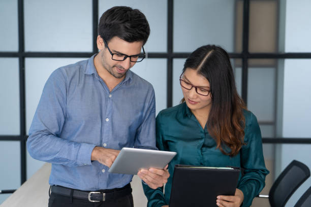 istock Caucasian supervisor helping new Asian employee 962126160