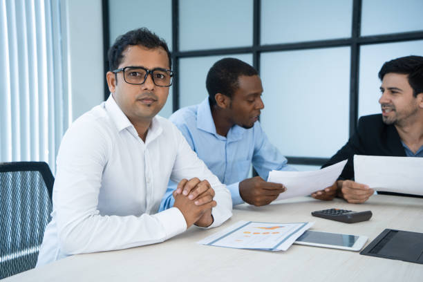 istock Multinational team of experts discussing business strategy 962126338
