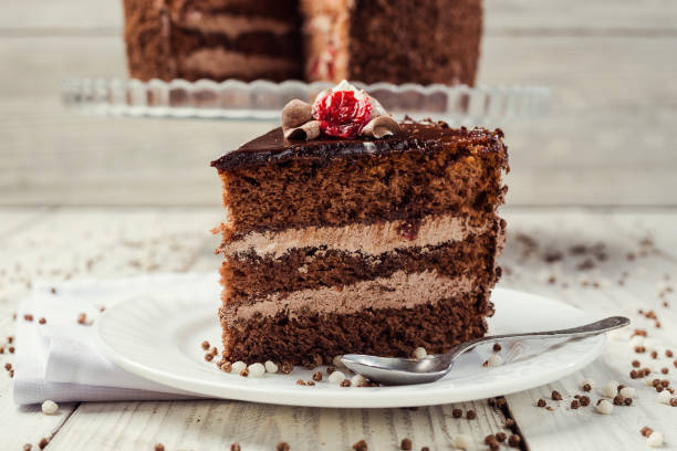 istock Dark chocolate vegan cake with cherries on wooden background 962126904