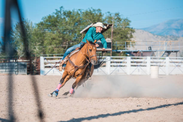 istock Young cowboy riding horse 962127096