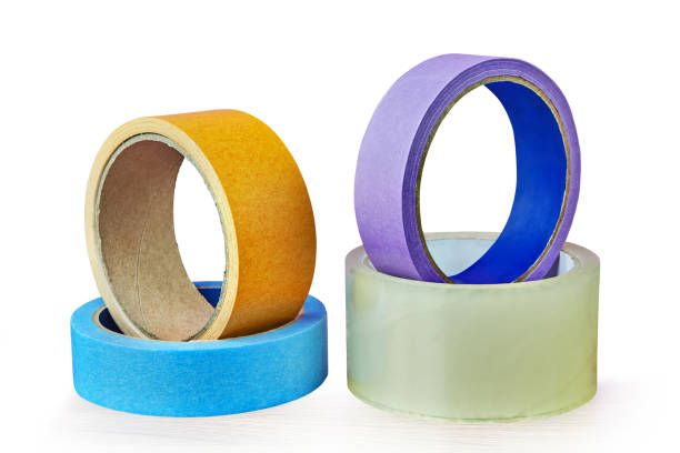 istock Four rolls of adhesive tape lying on table,  white background. 962131266