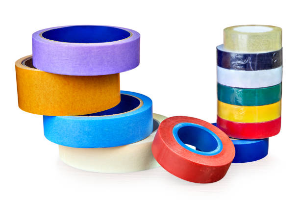 istock Two stacks of rolls of multi-colored adhesive tape,  on white. 962131324