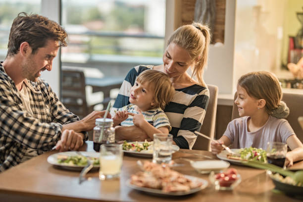 istock Happy family having fun during lunch time in dining room. 962135140