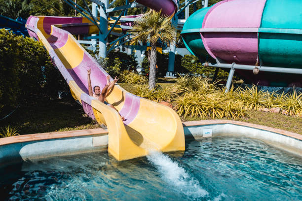 istock Man riding on a water slide in a water park 962135966