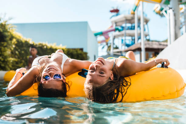 istock Women looking at the camera on floaties in the swimming pool 962135982