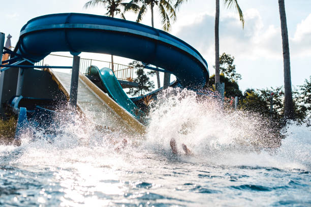 istock People riding down the water slides at a water park 962135986