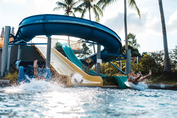 istock People riding down the water slides at a water park 962135988