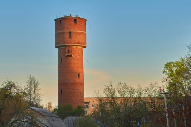 istock Old red towers water tower at sunrise or sunset 962144790