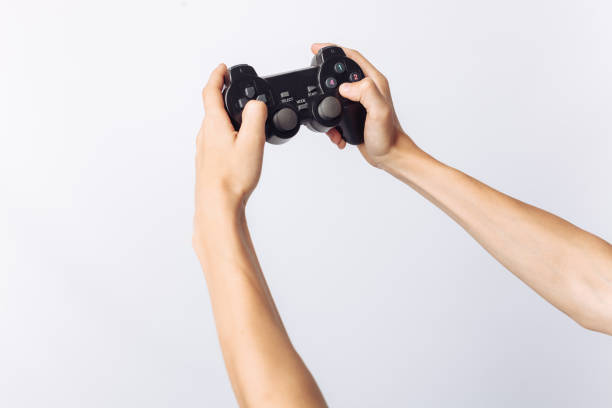 istock The image of hands that play games, stick, white background, insert text , advertising, 962145490