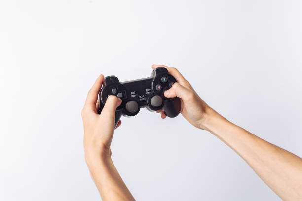 istock The image of hands that play games, stick, white background, insert text , advertising, 962145514