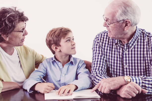 istock Grandparents Discussing Homework With Grandson 962147070