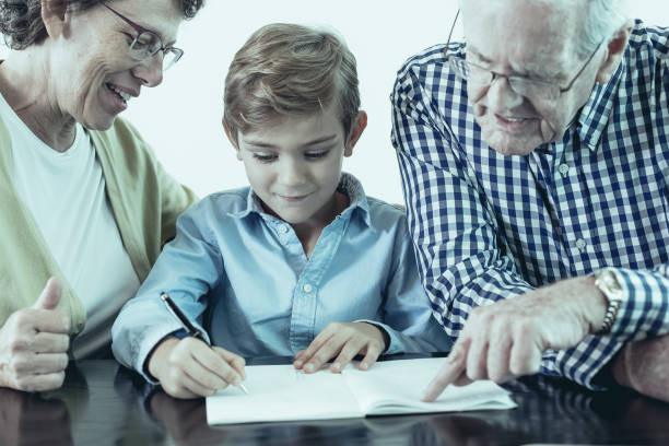 istock Senior Grandparents Helping Grandson With Homework 962147136