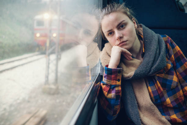 istock Young sad woman looking through the train window while travelling 962150292