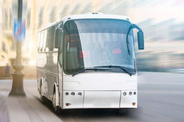 istock Modern transport bus on asphalt rides at high speed, front view. 962150610