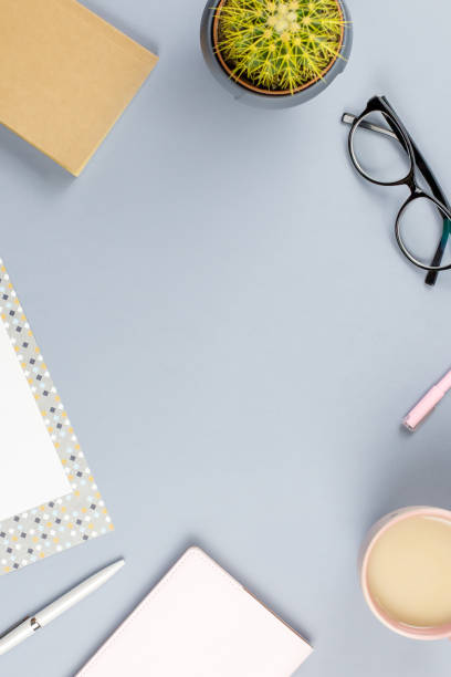 istock Flat lay home office desk. Female workspace with planner, eyeglasses, tea mug, diary, plant. Copy space 962155712