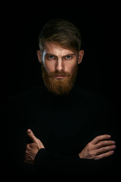 istock Portrait of serious young man with folded and crossing hands 962155900