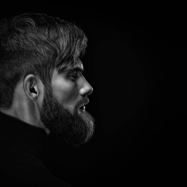 istock Black and white close up image of serious brutal bearded man on 962155934
