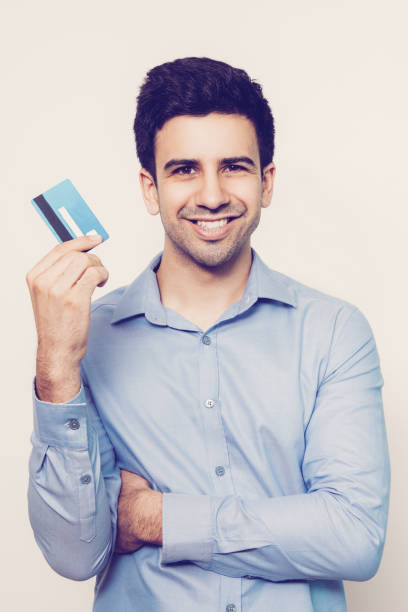 istock Smiling Young Attractive Man Holding Credit Card 962156694