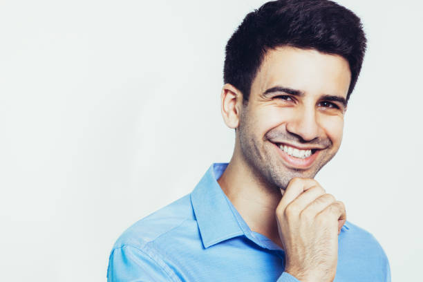 istock Smiling Young Attractive Man Touching Chin 962156704