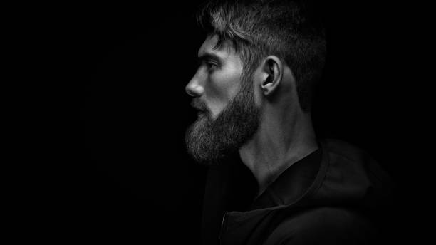 istock Single standing in profile young handsome serious bearded man in 962156728