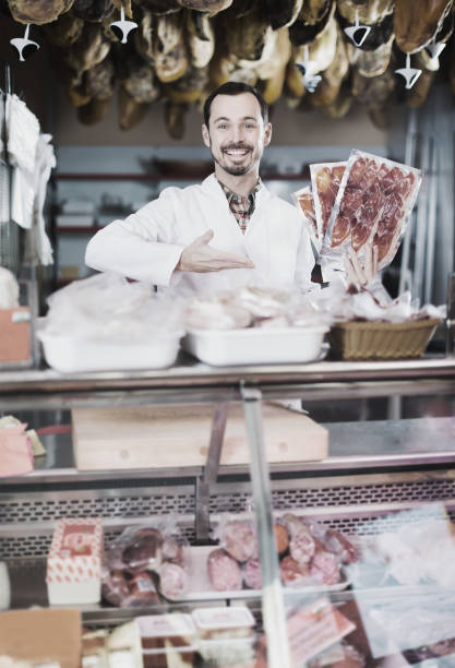 istock man seller showing sliced bacon in shop 962156870
