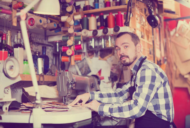 istock Adult man worker qualitatively stitching belt 962157266