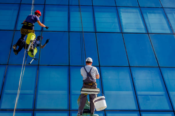 istock Industrial climbers are applying silicone on joints between windows 962157726