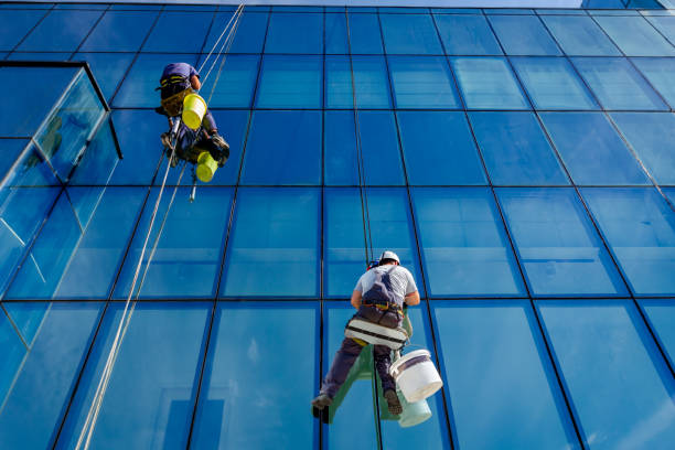istock Industrial climbers are applying silicone on joints between windows 962157790