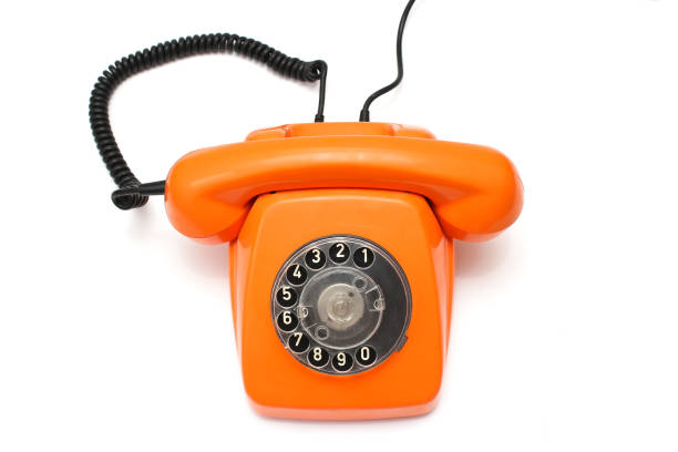 istock Orange retro telephone isolated on white background 962157936
