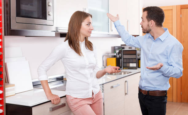 istock Couple talking in  kitchen furnishing store 962158062