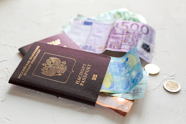 istock Several euros on white concrete table, passports and coins. 962158468