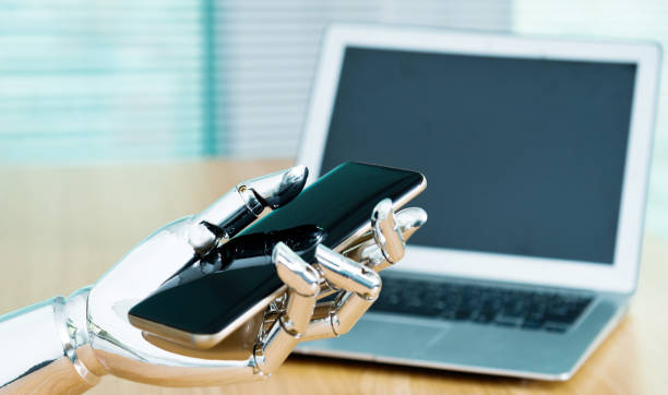 istock Robot's hand holding a mobile phone 962161140