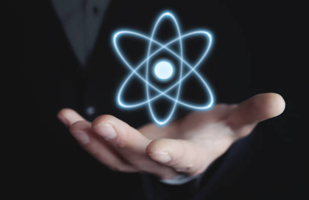 istock Caucasian businessman holding atom. Power and innovation concept 962161564