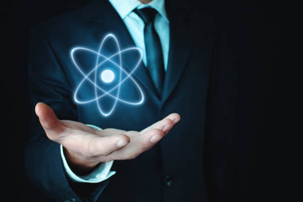 istock Caucasian businessman holding atom. Power and innovation concept 962161570