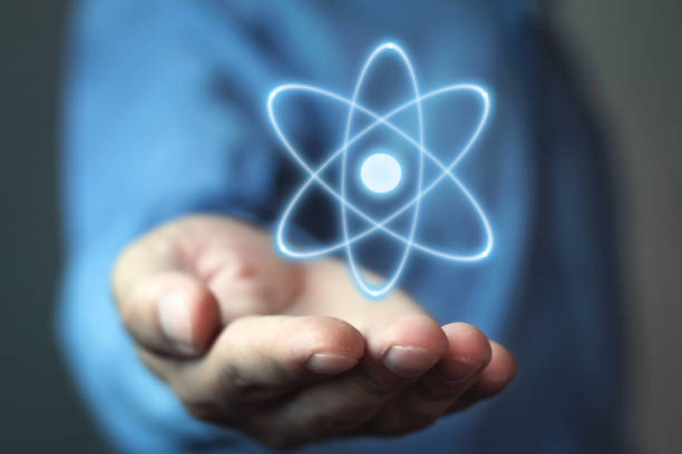 istock Caucasian businessman holding atom. Power and innovation concept 962161574