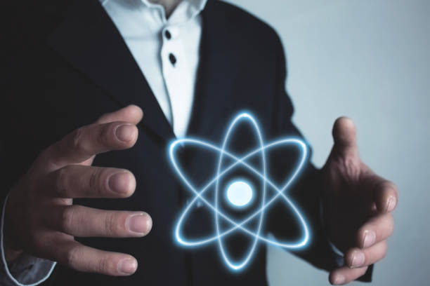 istock Caucasian businessman holding atom. Power and innovation concept 962161578