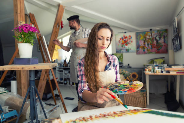 istock Fine art painters working in atelier together 962161684