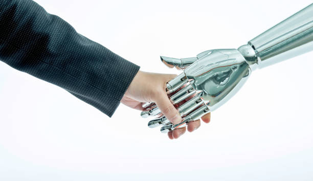 istock Businessman and robot shaking hands on white background 962162316