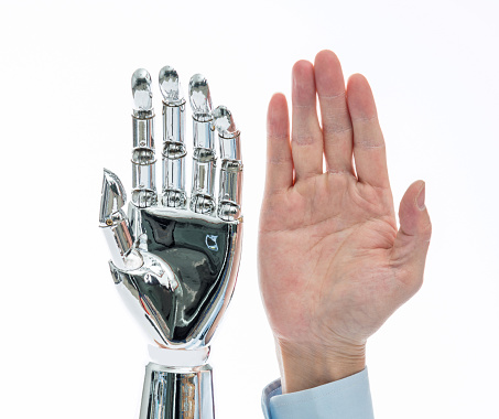 Robot hand and man hand on white background.