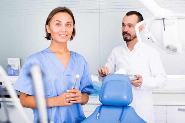 istock Dentist with assistant are fooling around in the workplace 962162718