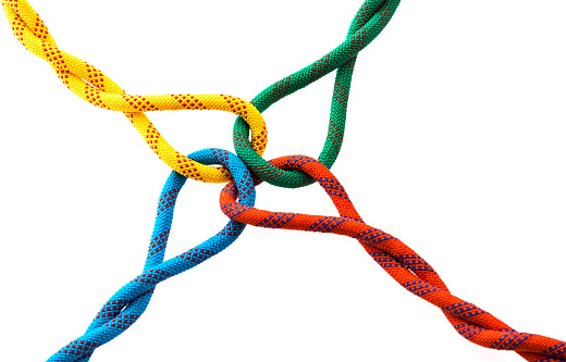 Colored ropes tied on white background.