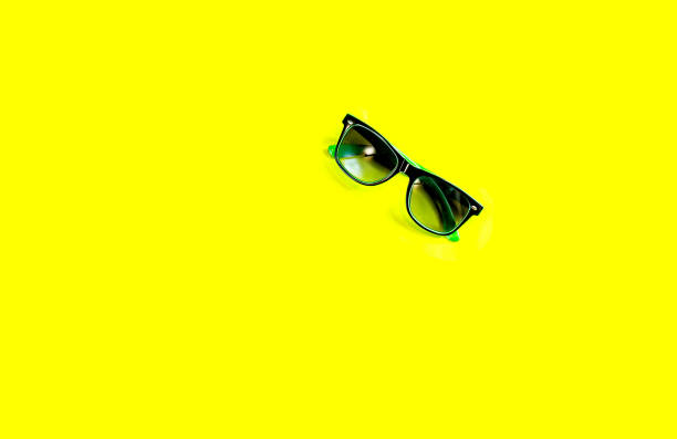istock green sunglasses on yellow background 962163952