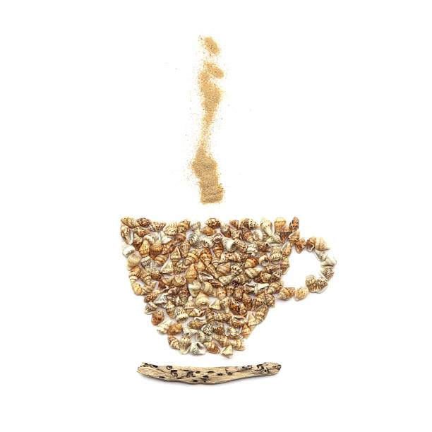 istock Coffee cup image created of sea shells, driftwood and sand isolated on white background. 962168346