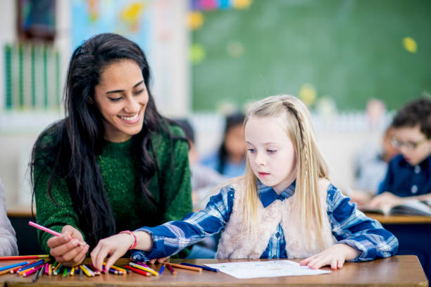istock Girl Drawing With Teacher 962169358