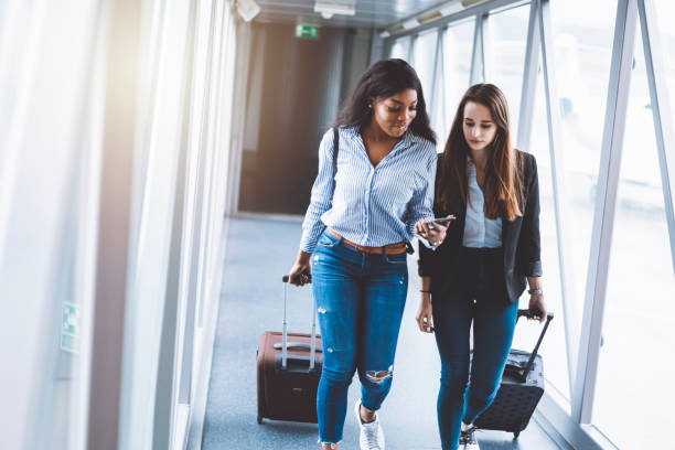 istock Young female using her phone to look at the flight number 962174060