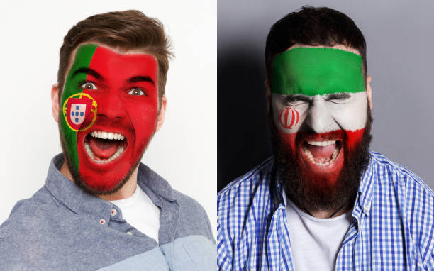 istock Emotional soccer fans with painted flags on faces 962174356