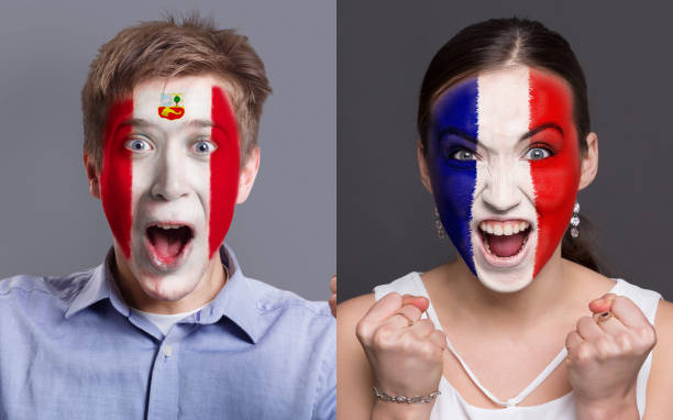 istock Emotional soccer fans with painted flags on faces 962174466
